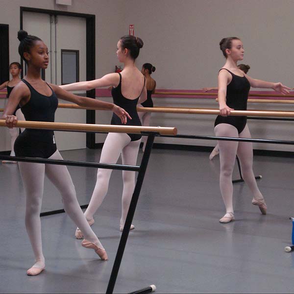 Academy students in class at the ballet barre.