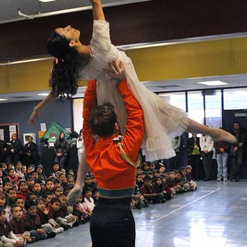 2 Nutcracker dancers perform for young, student audience.